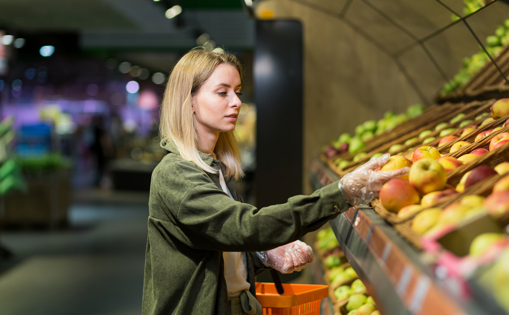 woman picking fruits in groceries
